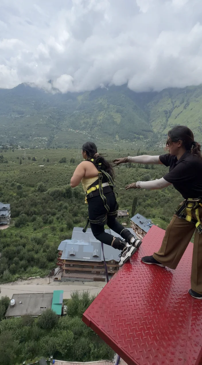 Bungee Jumper Preparing at Platform Edge Facing Himalayan Valley