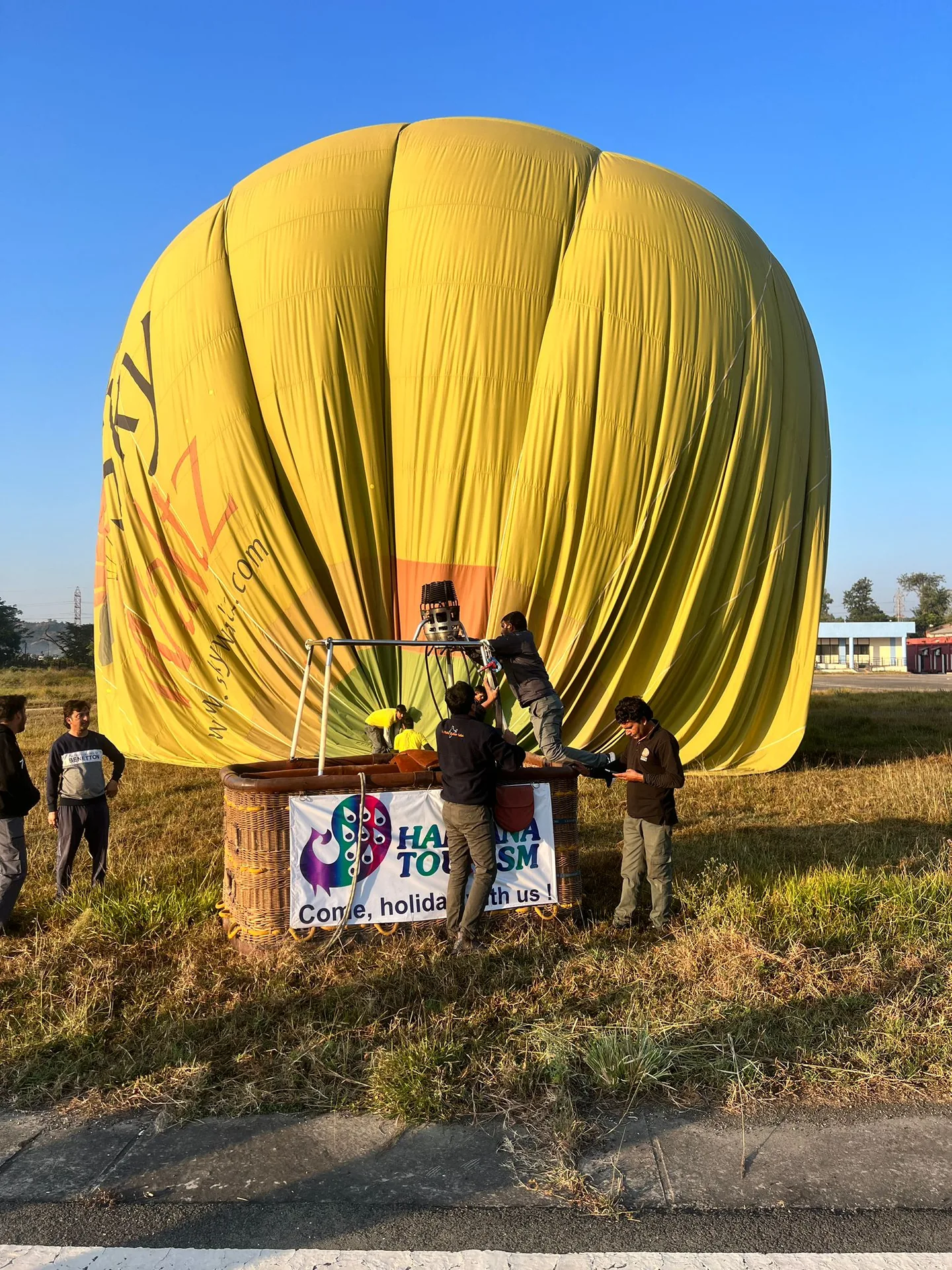 Giant Yellow Hot Air Balloon Fully Inflated on Launch Field