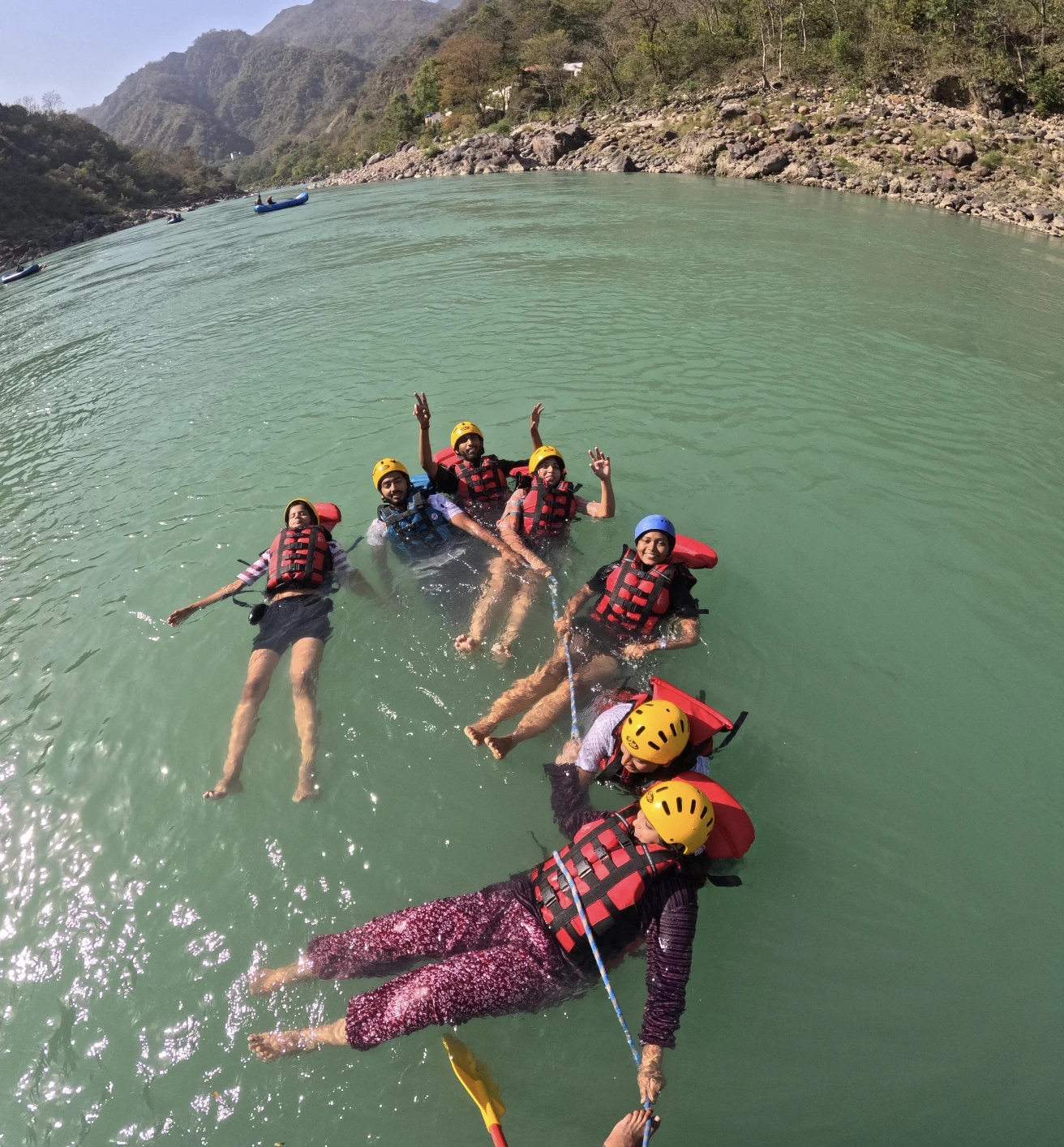 Relaxed Body Surfing in Life Jackets on Emerald Waters