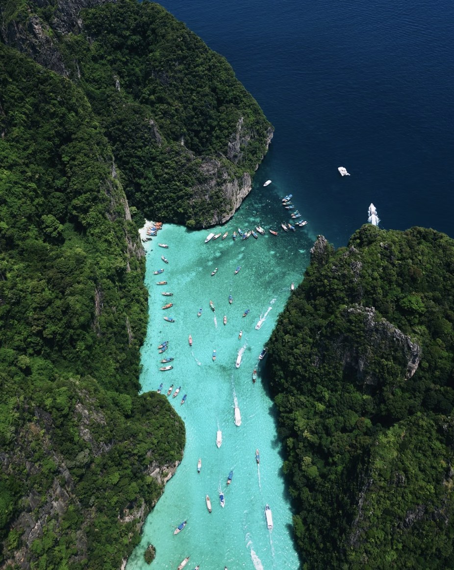 Tropical island lagoon with emerald green shallows and crystal clear waters