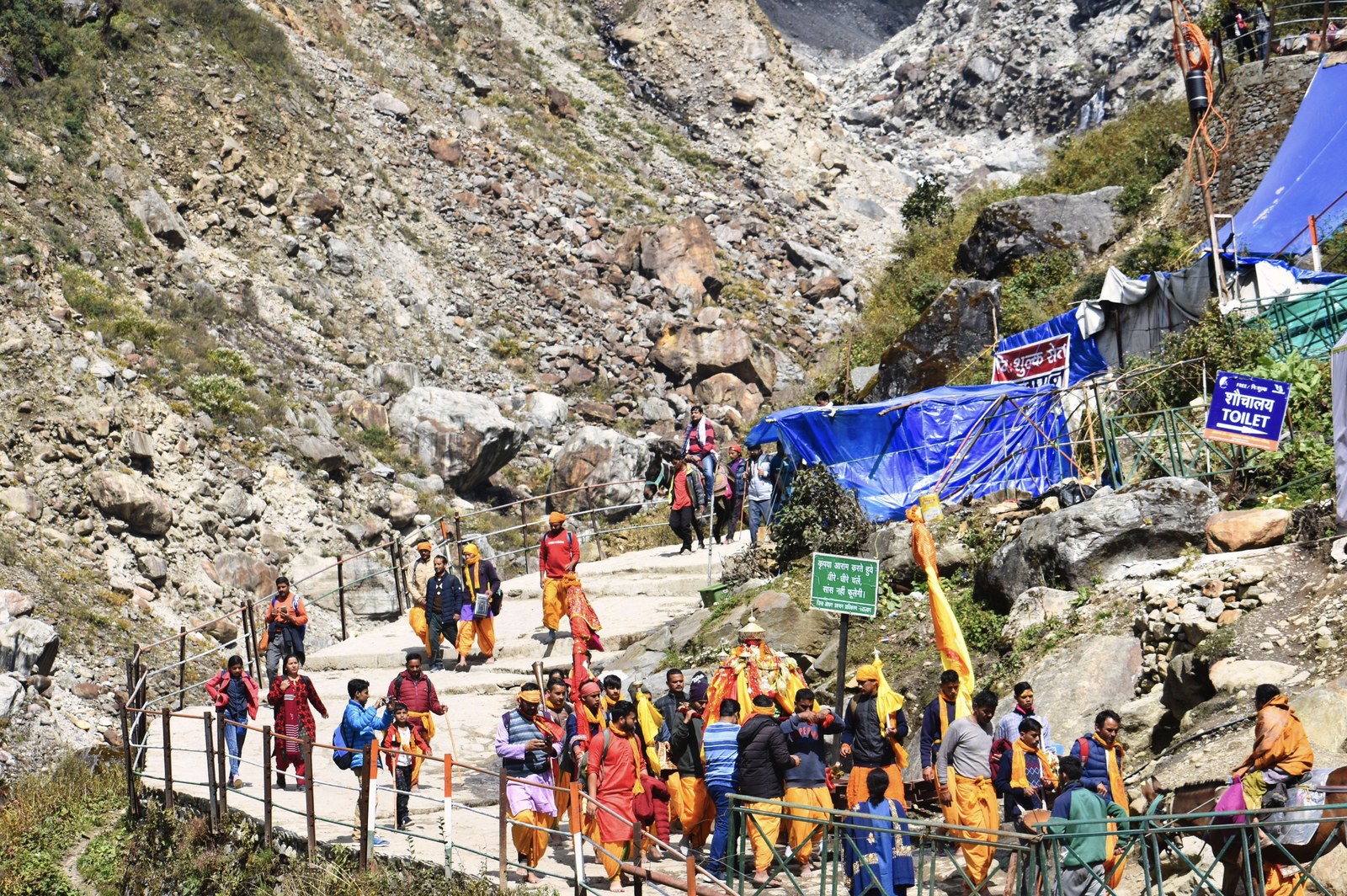 Devoted pilgrims ascending the rugged Himalayan mountain trail on the sacred Yatra route