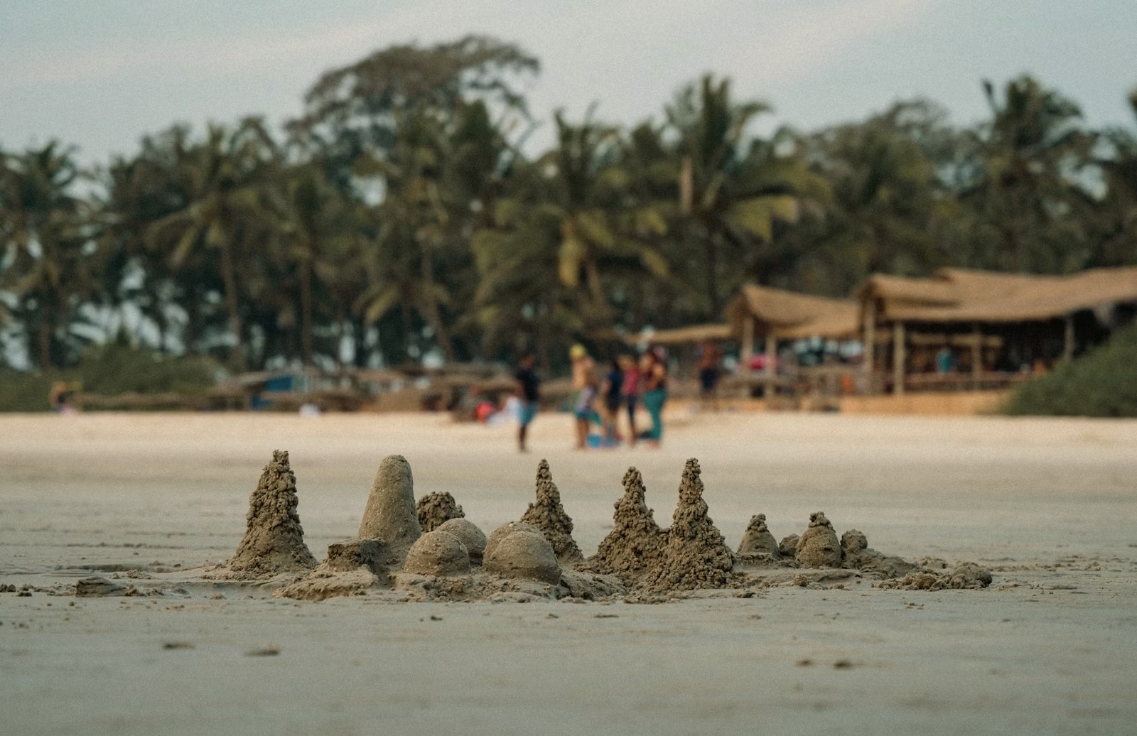 Relaxing beach shacks, golden sands, and coconut palms