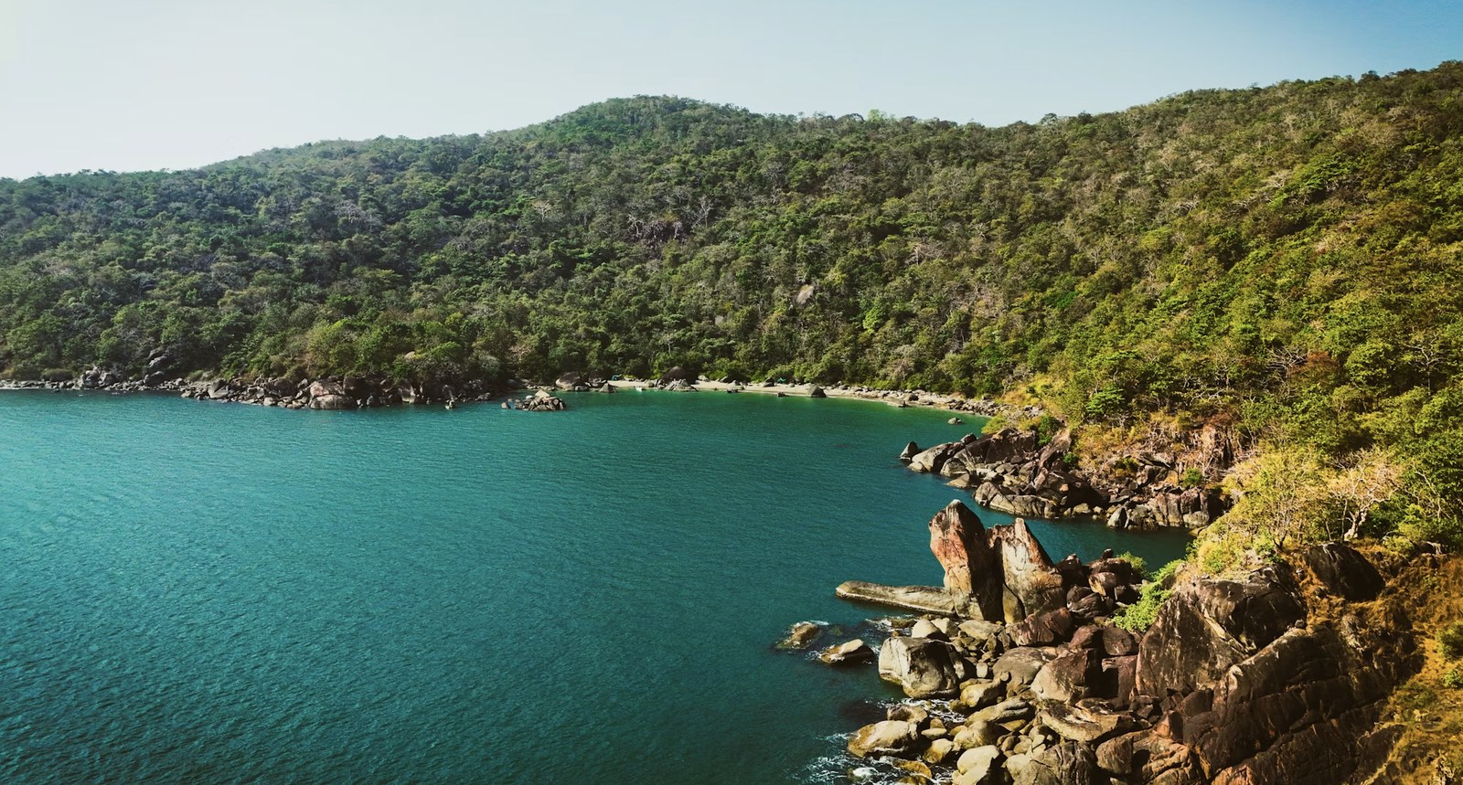 Secluded turquoise cove and lush green hills of South Goa