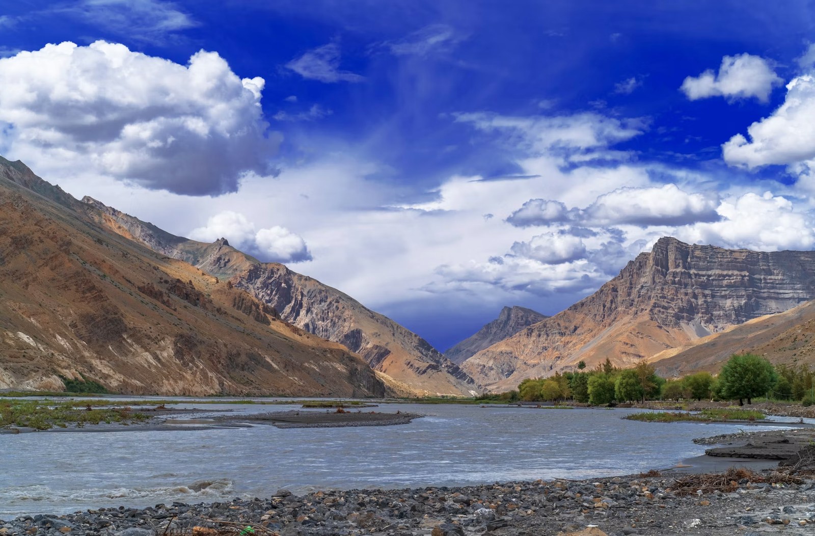 Vibrant blue skies and sweeping mountain river valleys of Ladakh