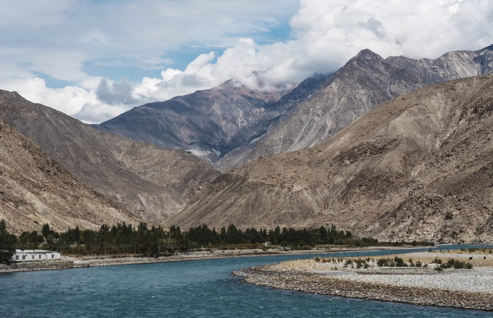 Glacial turquoise Indus river meandering through rugged Himalayan mountains