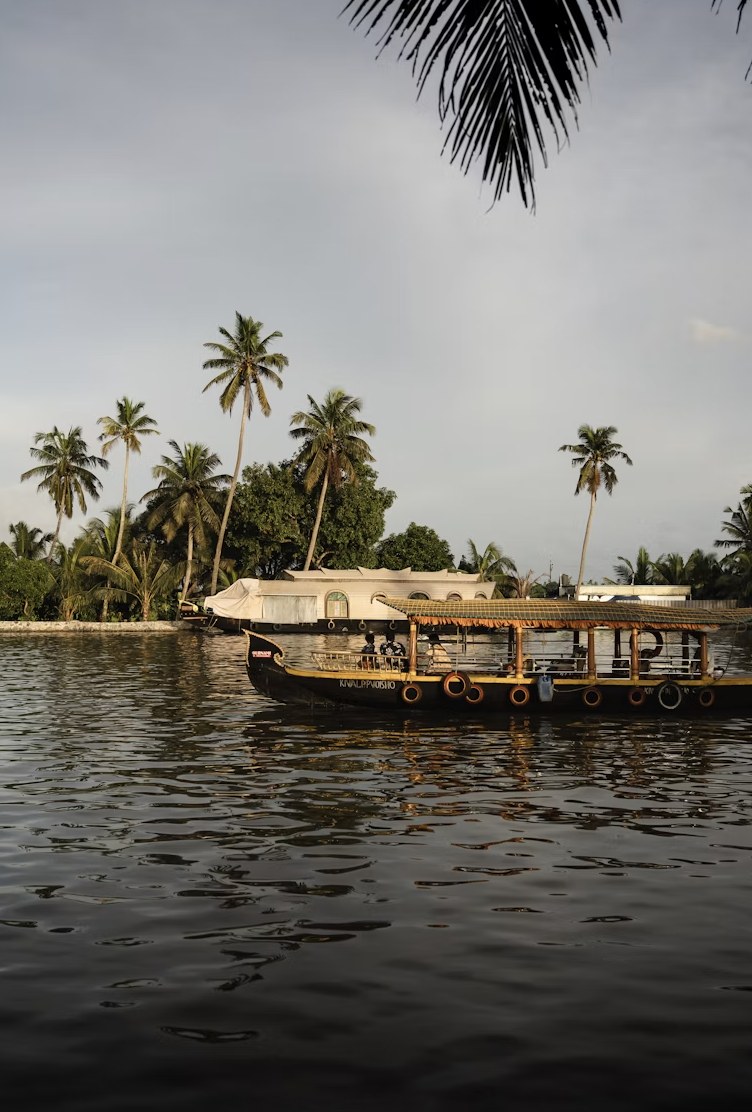 Traditional wooden houseboat sailing at dusk