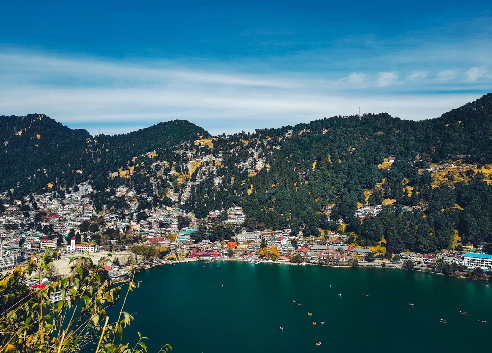 Vibrant hillside settlements framing the scenic crescent-shaped lake