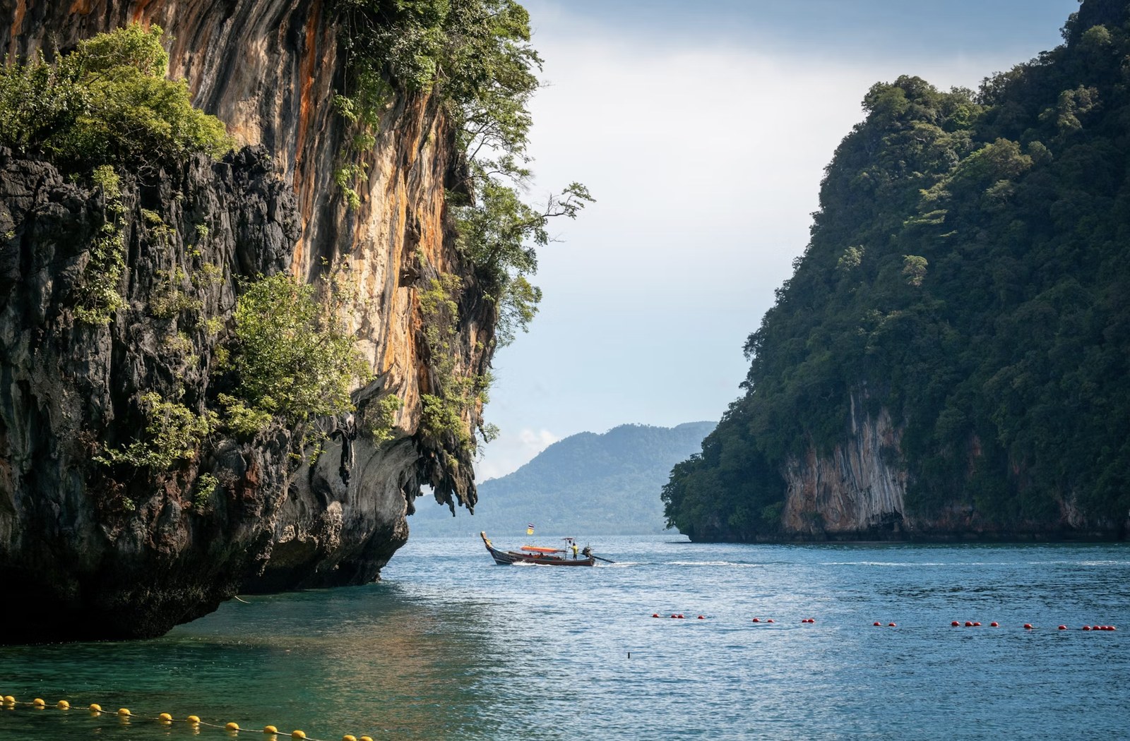 Majestic limestone cliffs rising above azure sea waters