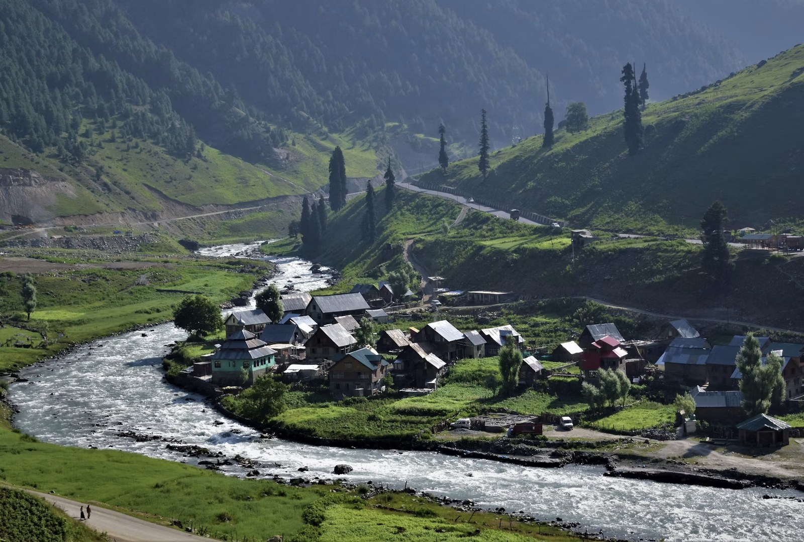 Picturesque Kashmiri village flanked by winding rivers and emerald mountains