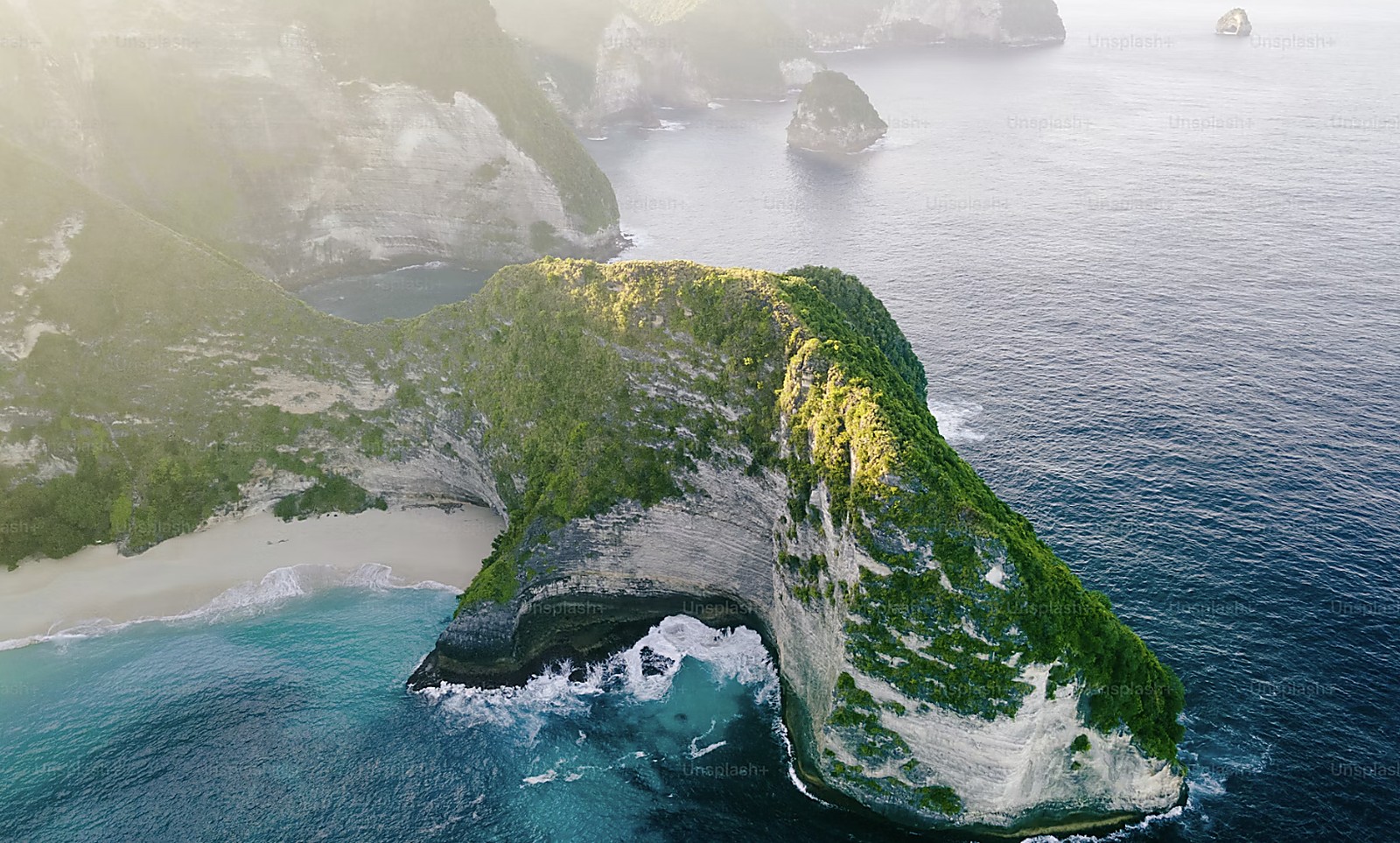 Sweeping view of pristine tropical island coastline and sparkling blue bay