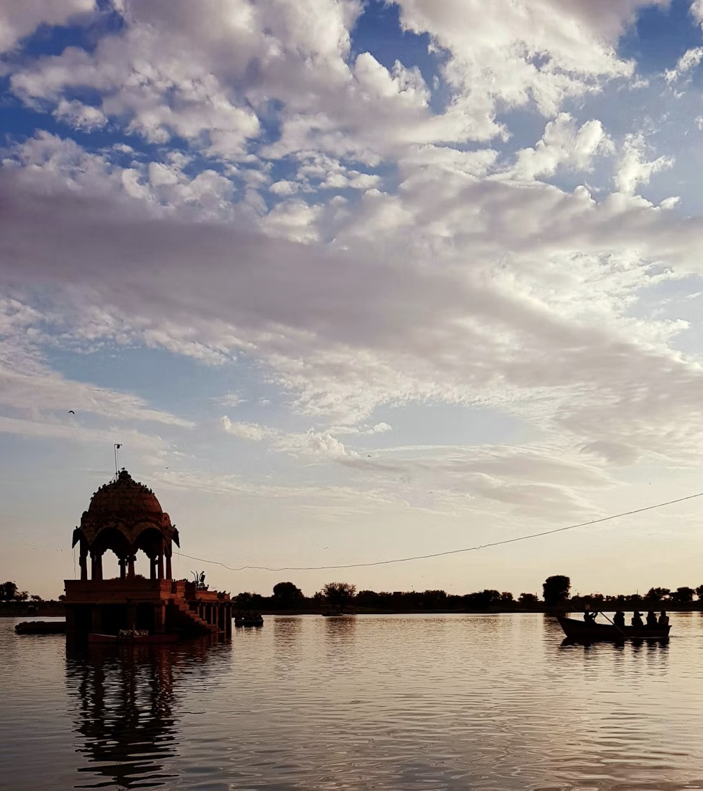 Historic sandstone cenotaph pavilion on Gadisar Lake at sunset, Jaisalmer