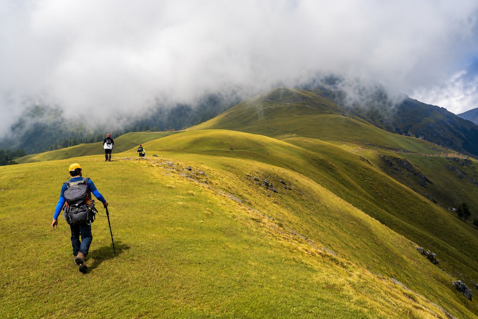 Trekker navigating the verdant high-altitude ridge