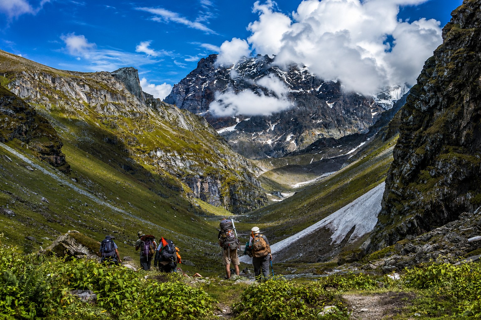 Trekkers traversing dramatic high-altitude valley landscapes