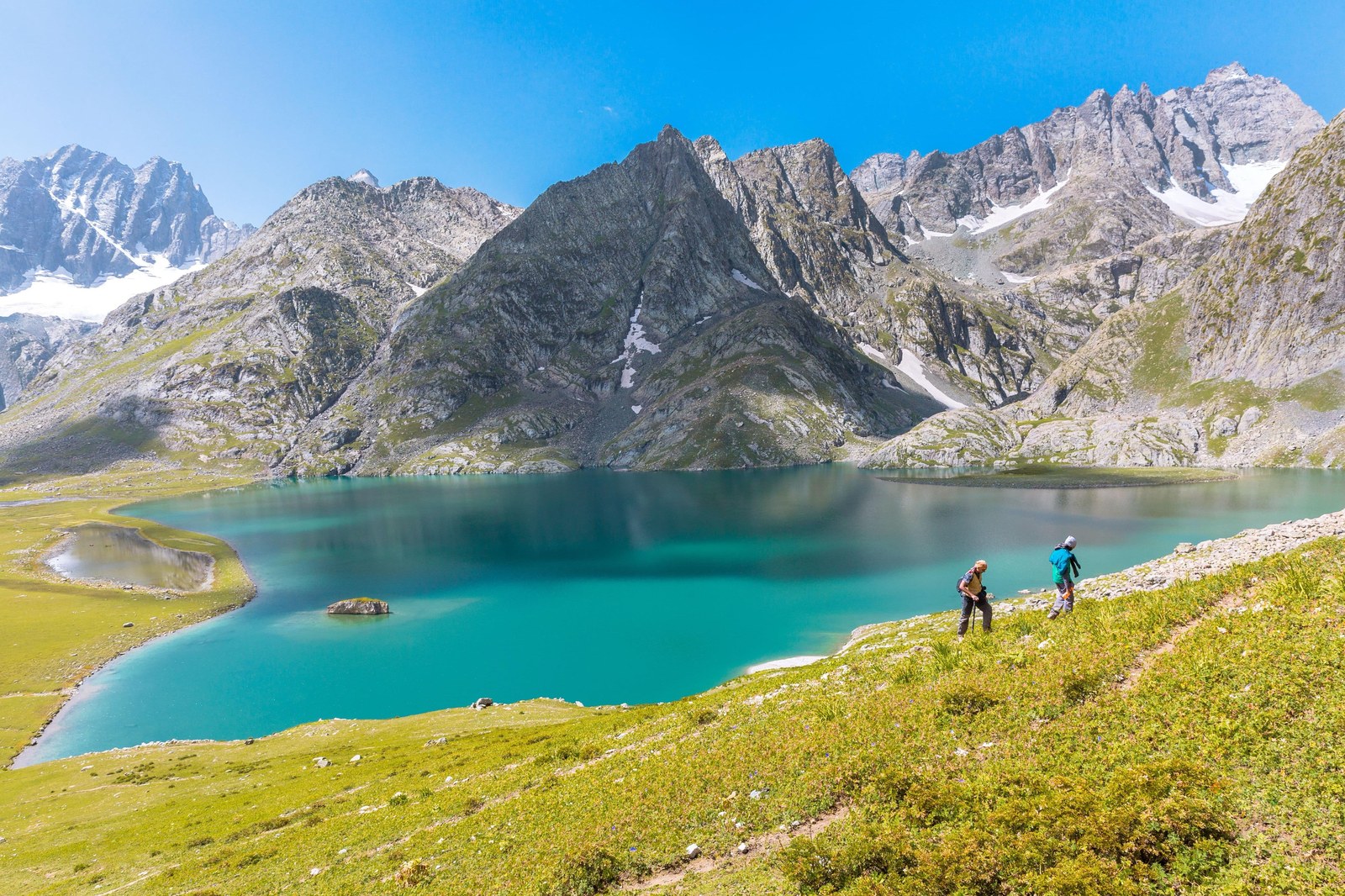 Trekkers taking in the turquoise alpine lake vistas