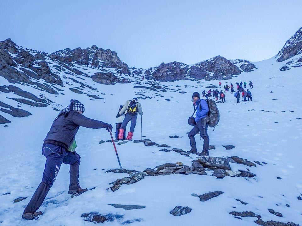Trekkers navigating high-altitude snowy passes
